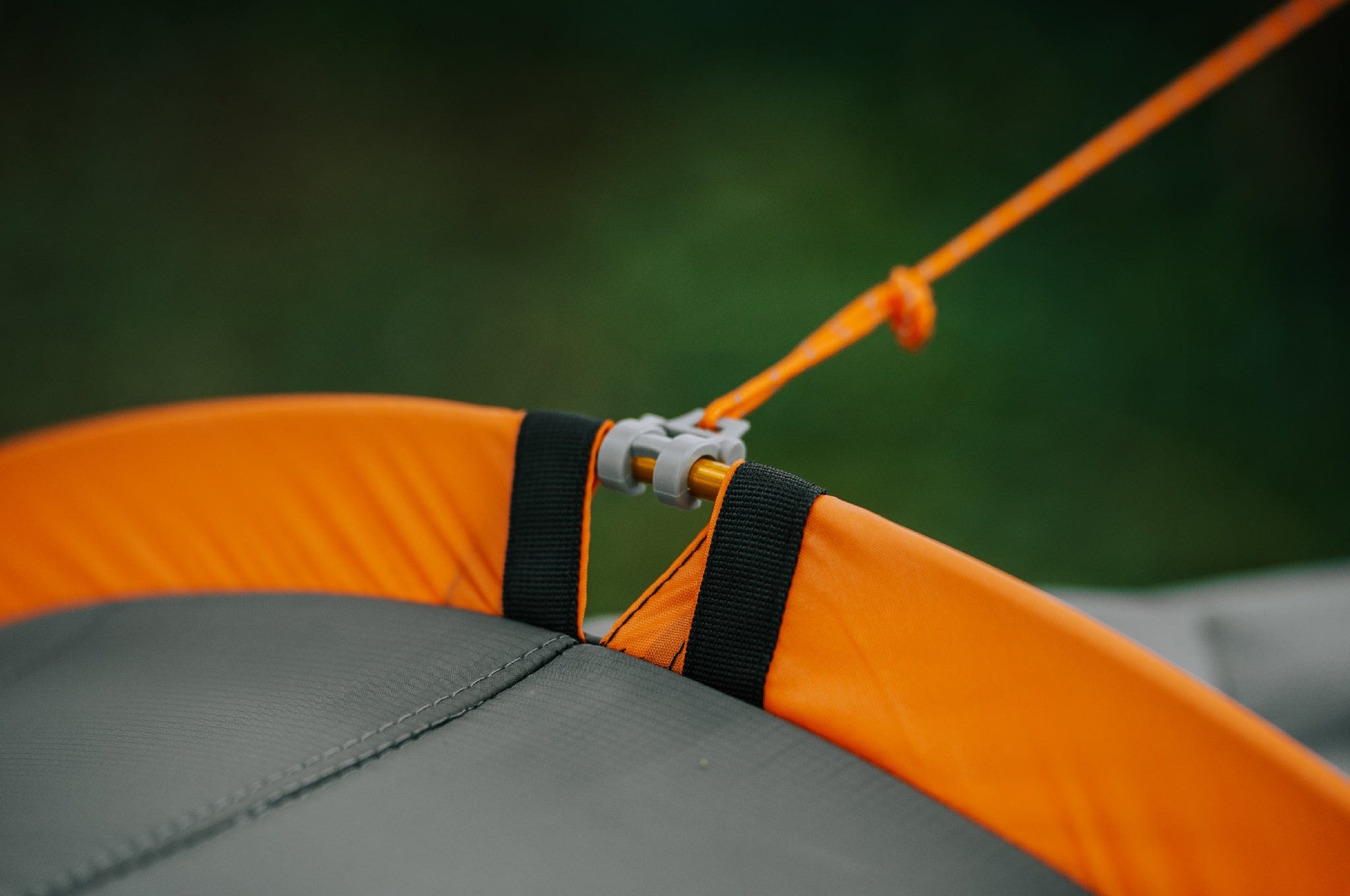 Close-up of the grey hook connected to the spreader bar on the Crua Culla Hammock Wrap, highlighting the quality of the spreader pole sleeves.