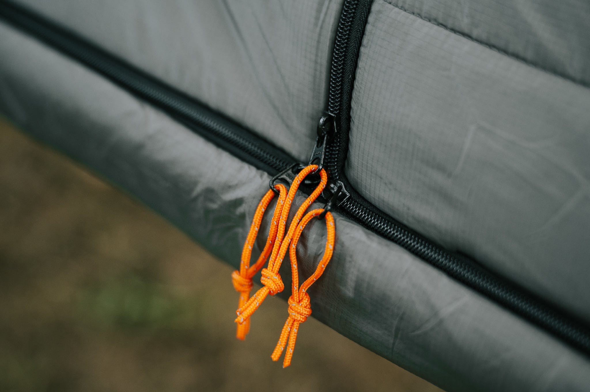 Close-up of the zippers and orange toggle on the Crua Culla Hammock Wrap, designed for easier access and usability.