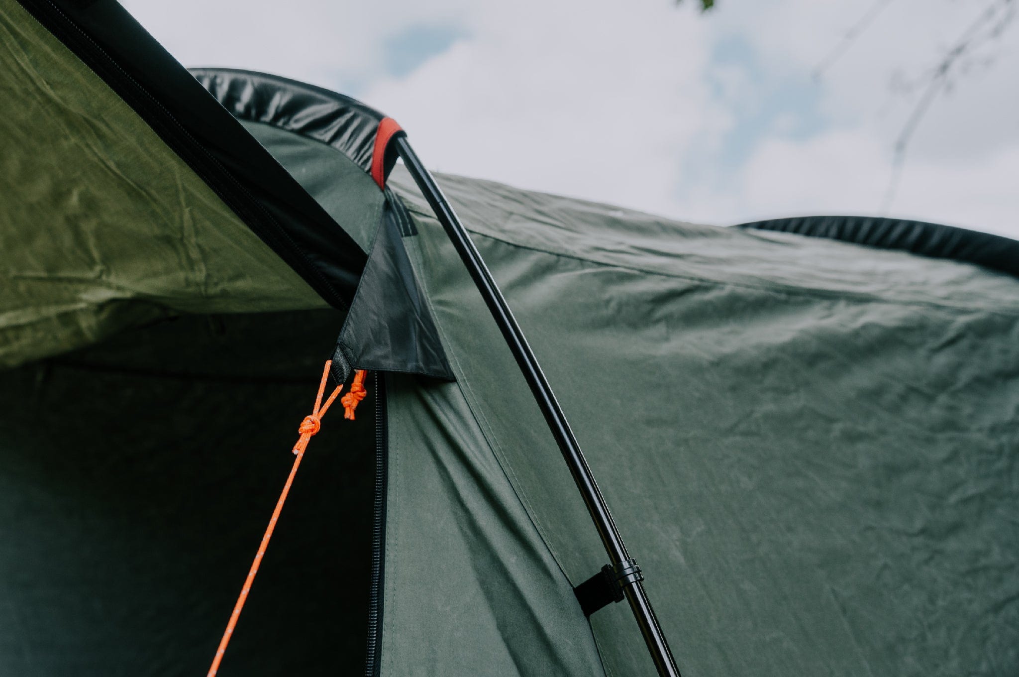 Close-up of Crua Tri tent pole and insulated fabric detail against the sky, built for extreme weather.