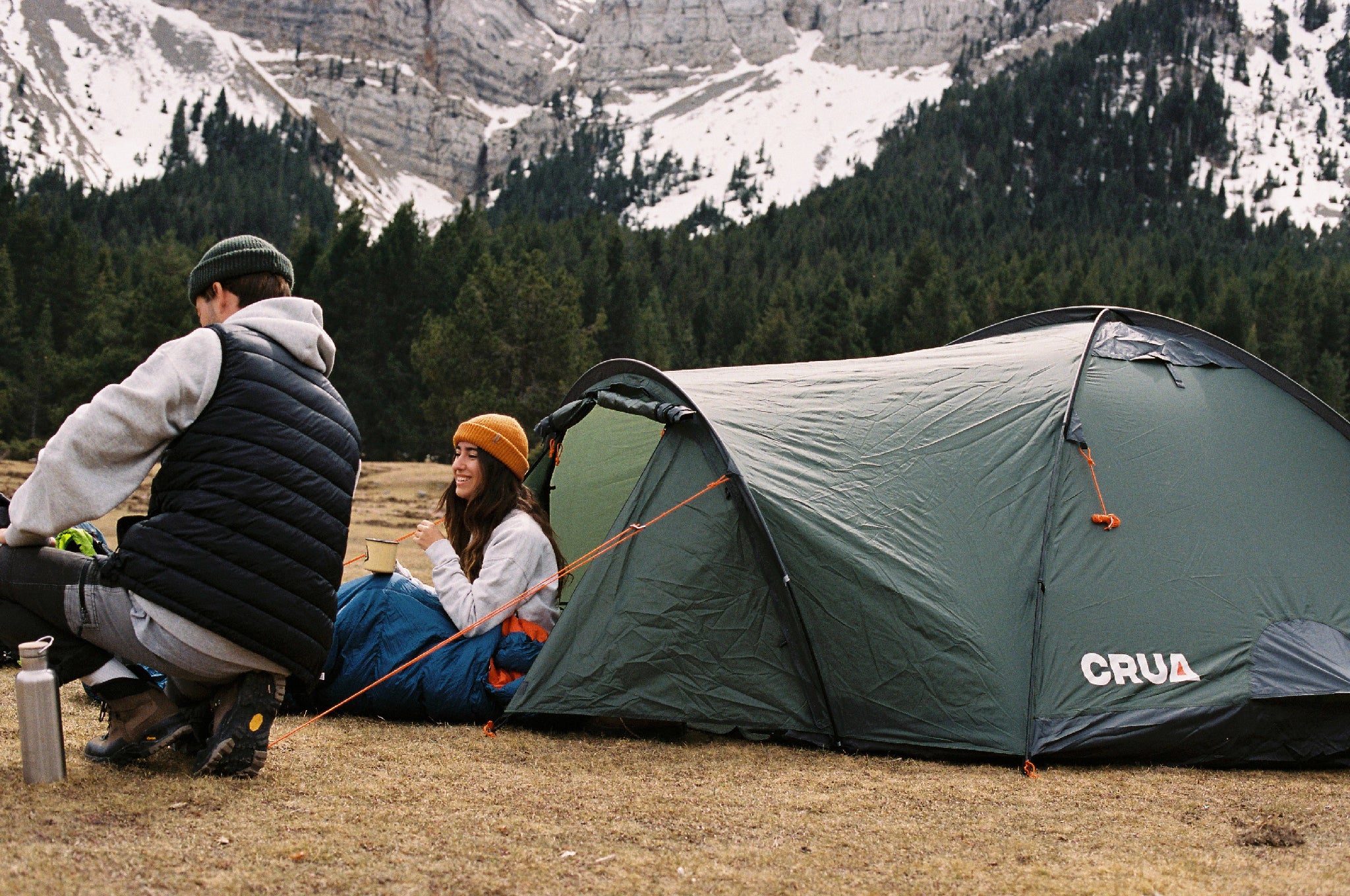 "Duo GS Maxx set up in a snowy mountain landscape with two campers relaxing, highlighting its 4-season durability."