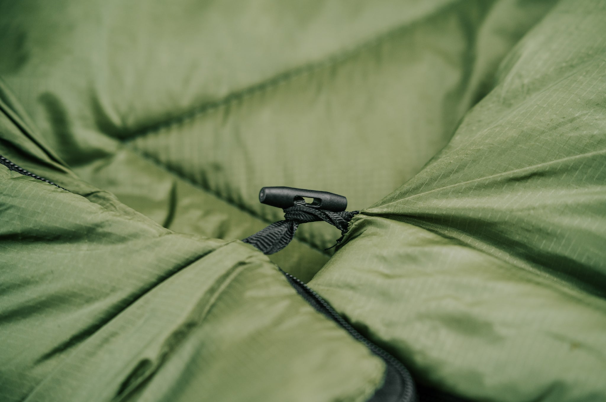 Close-up shot of the toggle and bone on the Crua Graphene Sleeping Bag, used to connect two bags together