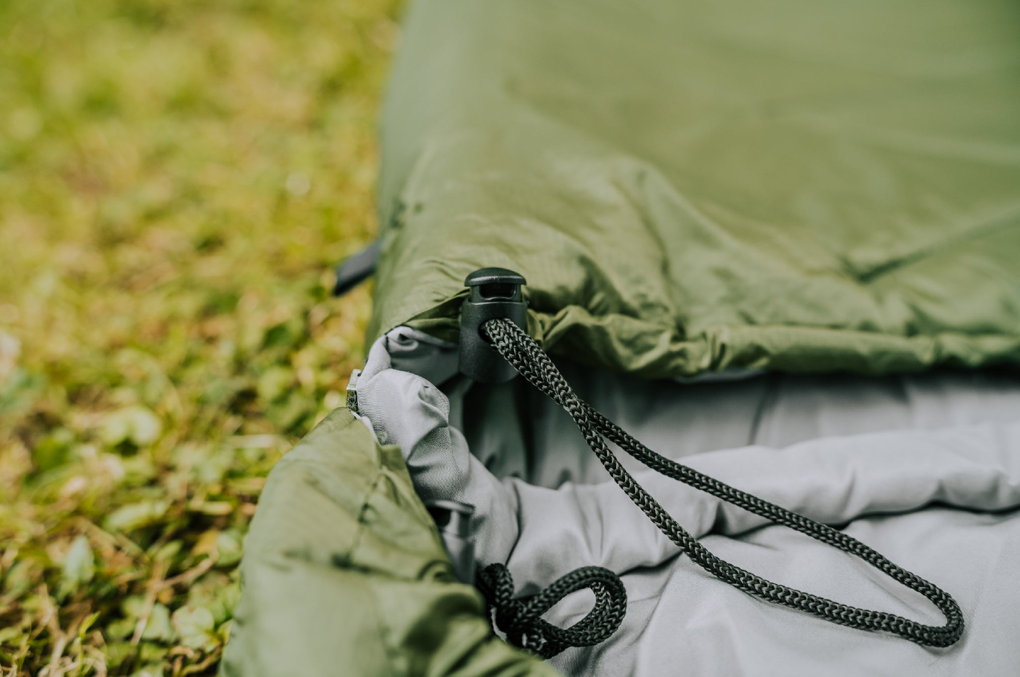Close-up of the toggle on the Crua Graphene Sleeping Bag for tightening around the neck area.